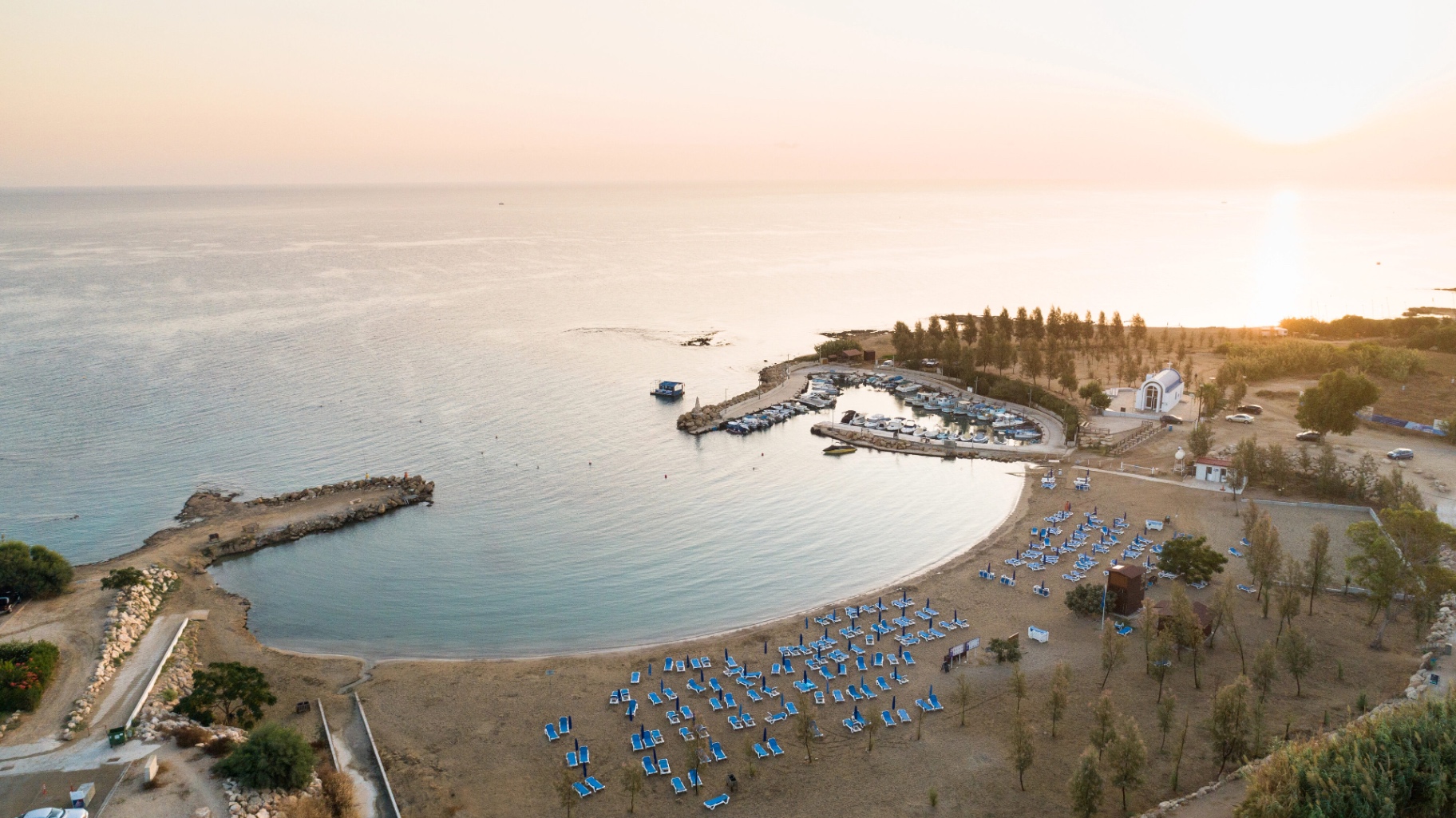 Aerial view of a calm Cyprus bay at sunset
