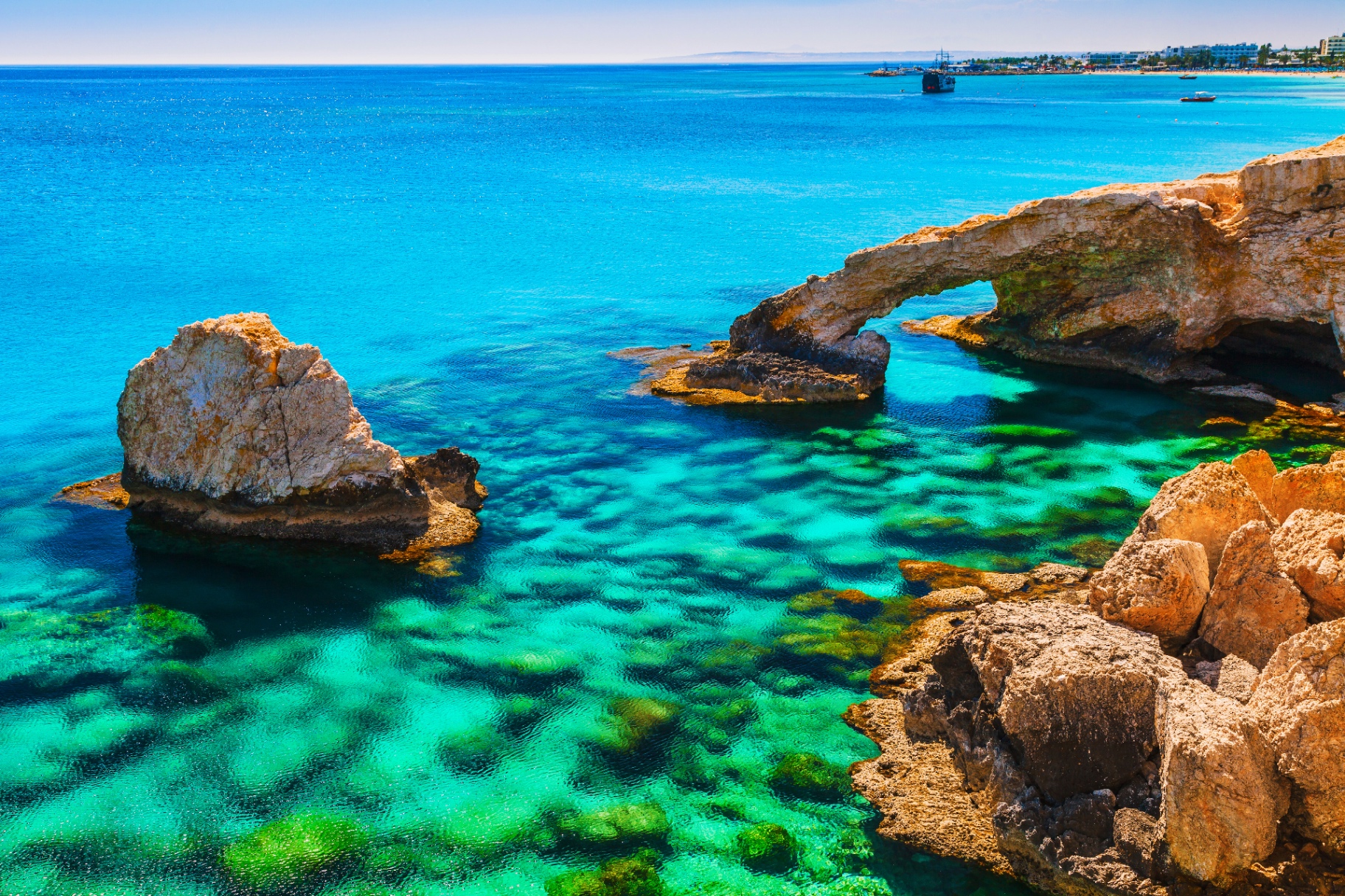 Natural stone arch over turquoise Mediterranean, a structured passage
